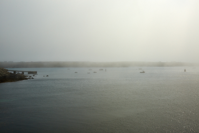 Beneath the blanket of fog, the coast of Ouessant is more visible than it is revealed - pure mystery and beauty, where the sea and the sky merge.