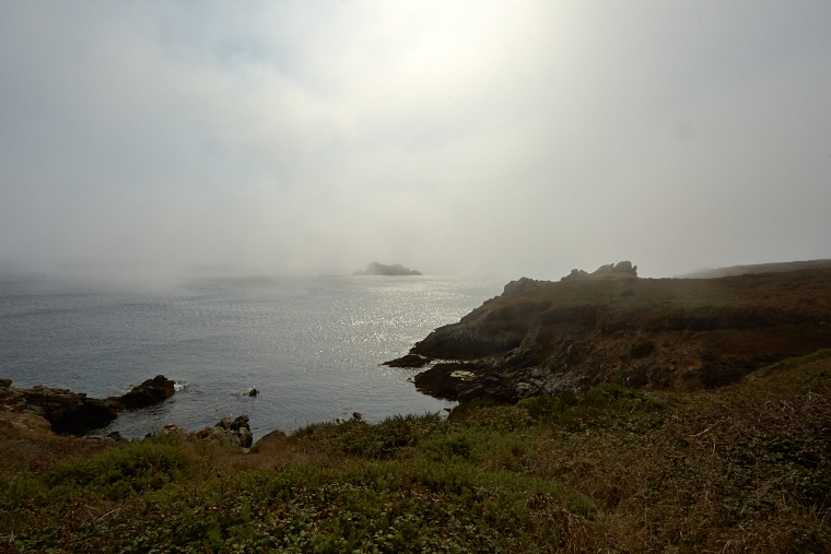 Beneath the blanket of fog, the coast of Ouessant is more visible than it is revealed - pure mystery and beauty, where the sea and the sky merge.